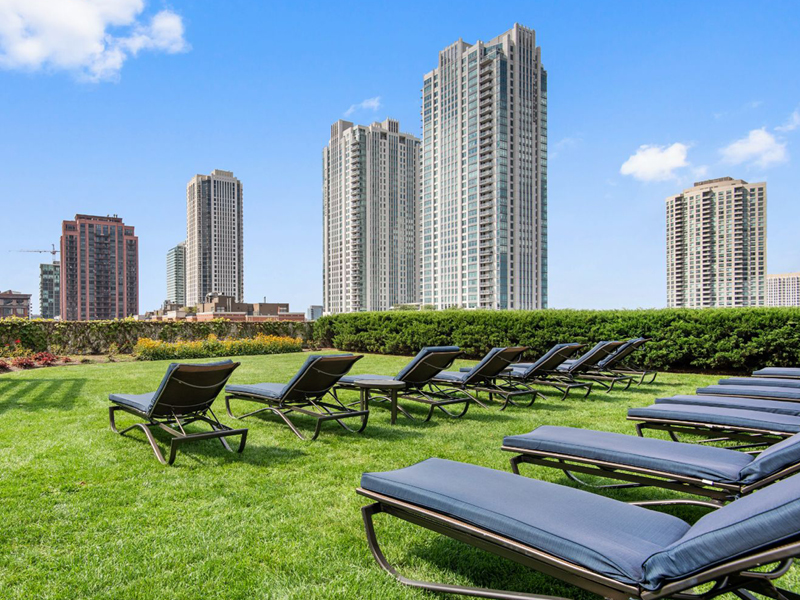 Landscaped sky terrace with loungers and wide views of Chicago