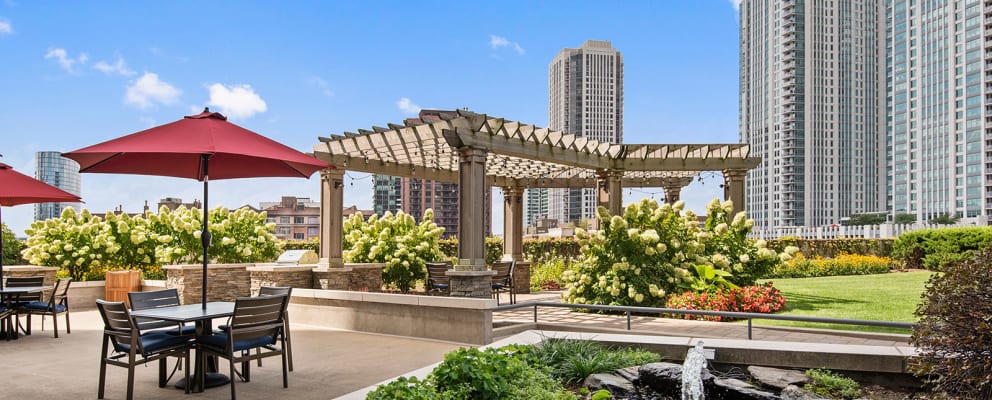 Spacious, landscaped outdoor terrace with lush seating, grills and a fire pit